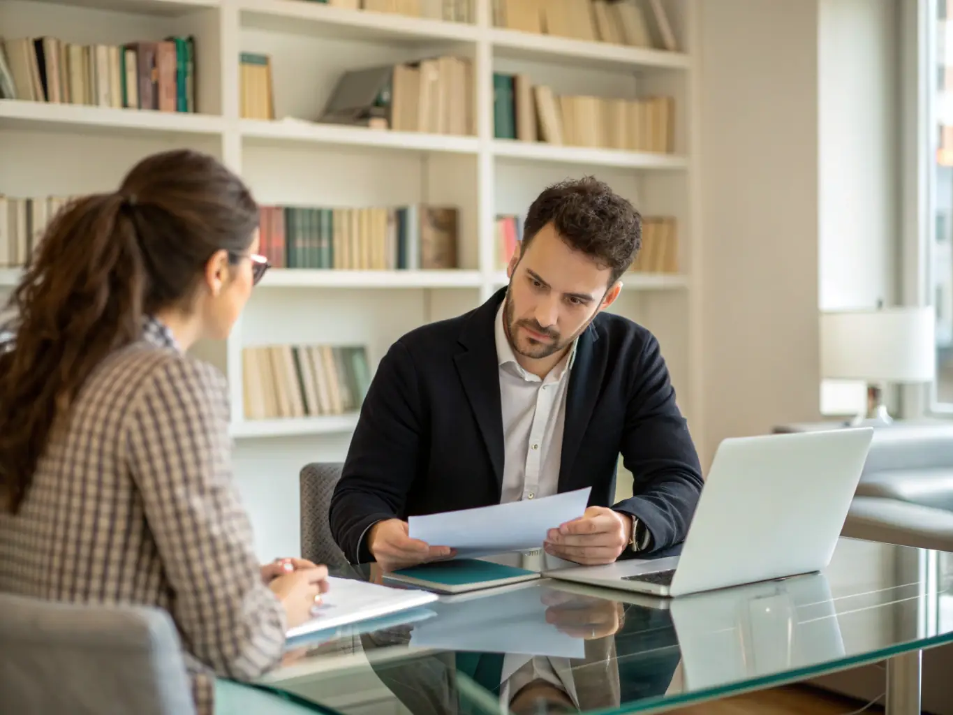 A dynamic image of a leader confidently addressing a team in a modern office, symbolizing leadership development coaching.